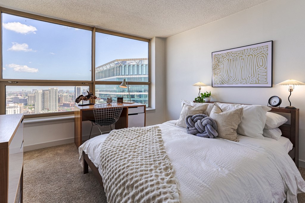 a bedroom with a bed and a view of the city