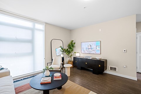 A living room with a black coffee table and a white chair.