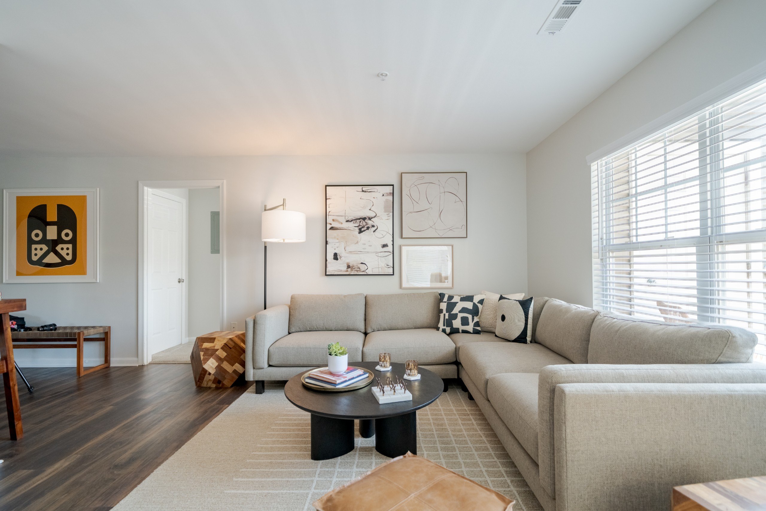 A living room with a grey couch and a coffee table.