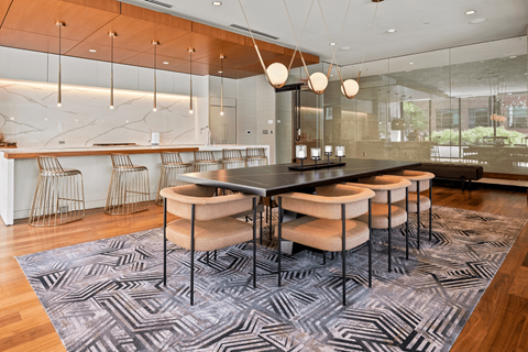 A modern dining room with a black table and chairs.