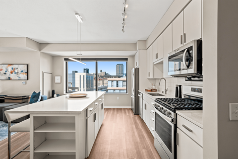 A modern kitchen with a view of the city.
