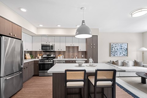 A modern kitchen with a dining table and chairs.