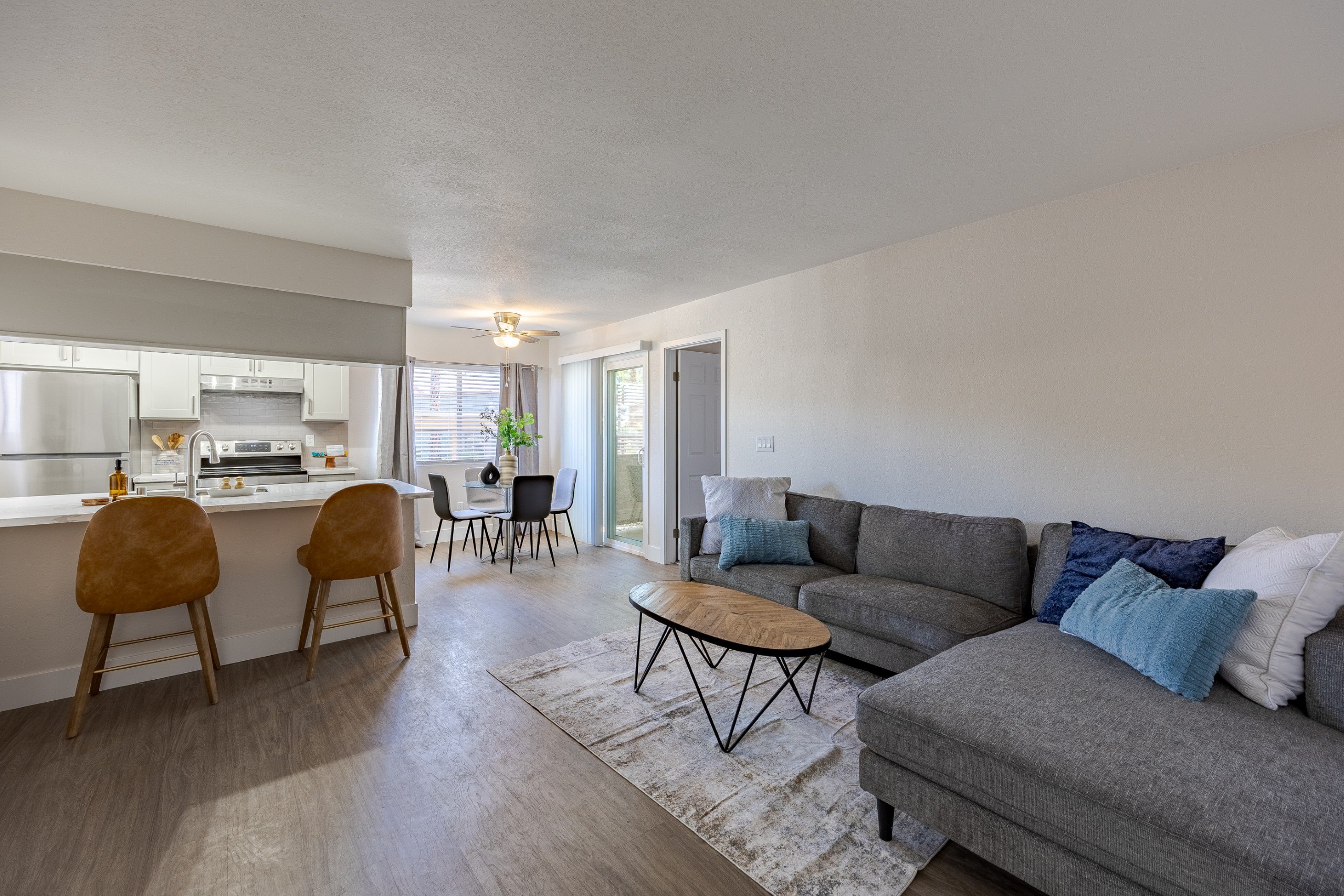 A living room with a grey couch and a coffee table.