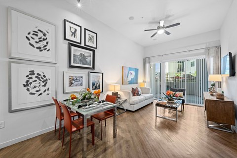 A modern dining room with a glass table and chairs.
