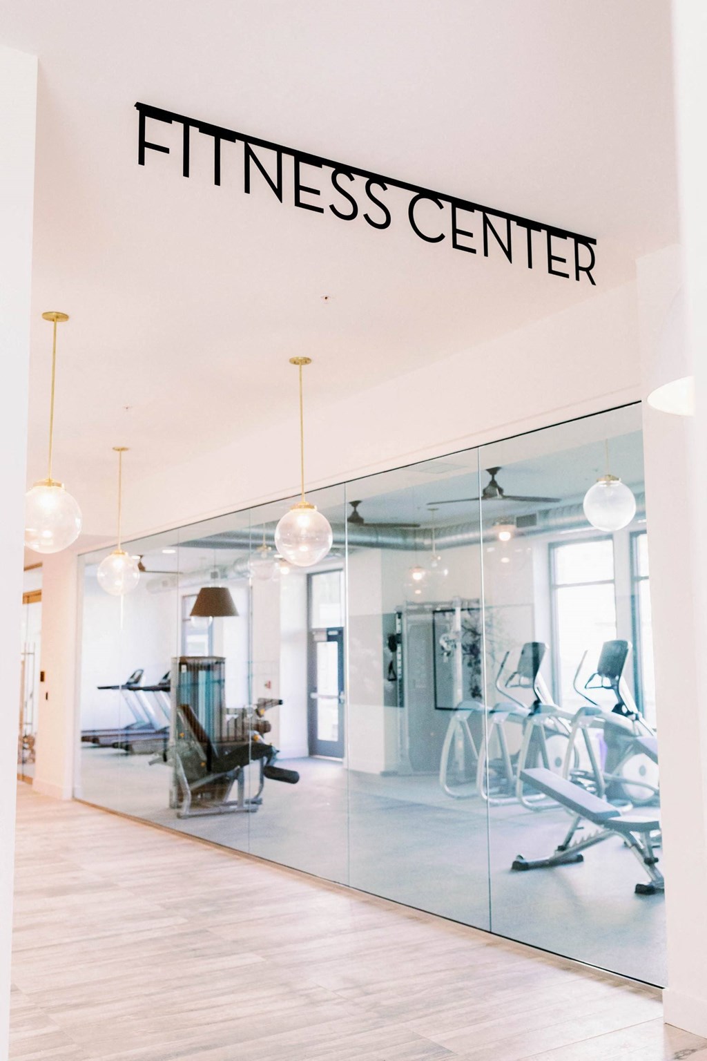 Entry to the fitness center with glass walls at The Merchant Apartments, Charleston, SC