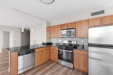 A modern kitchen with wooden cabinets and stainless steel appliances.