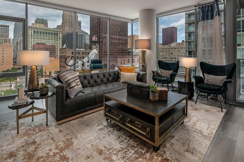 a living room with a city view and a couch and a table