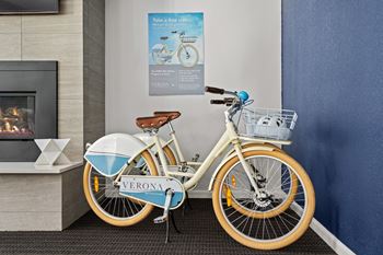 a bike parked next to a wall in a lobby at Verona, Littleton, CO