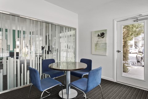 a dining area with blue chairs and a glass table  at Verona, Littleton, 80123