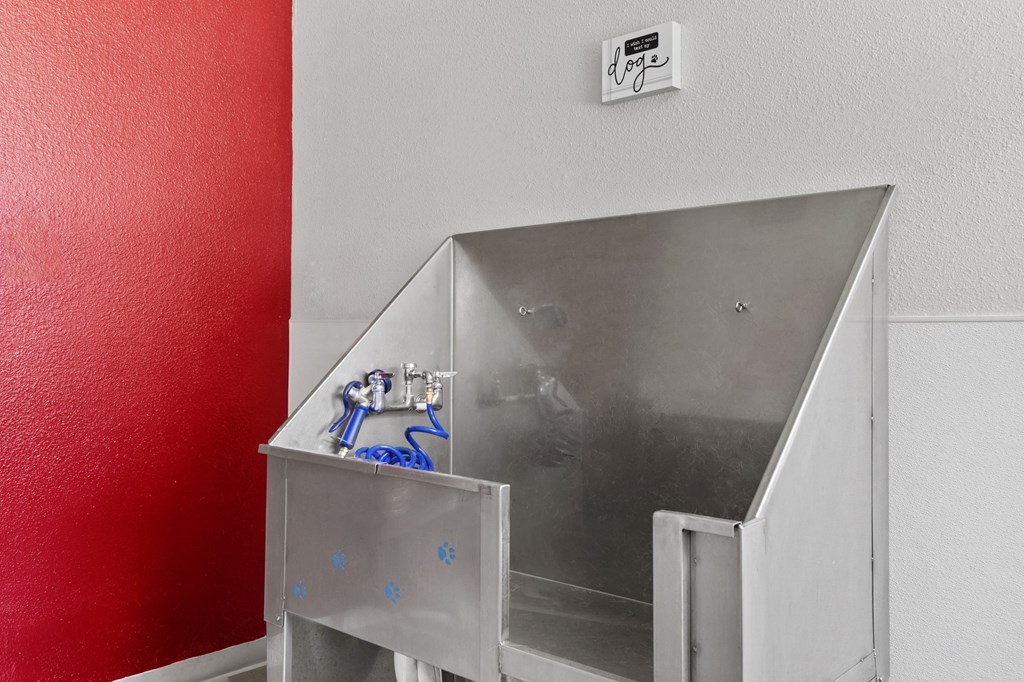 a stainless steel bathroom with a sink and a red wall  at Verona, Colorado, 80123