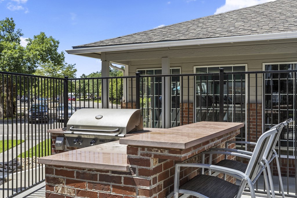 a patio with an outdoor grill and a table with chairs  at Verona, Littleton, CO, 80123