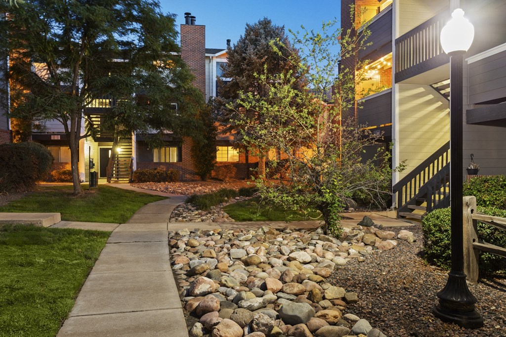 a walkway with a sidewalk and rocks in front of a house  at Verona, Littleton, CO