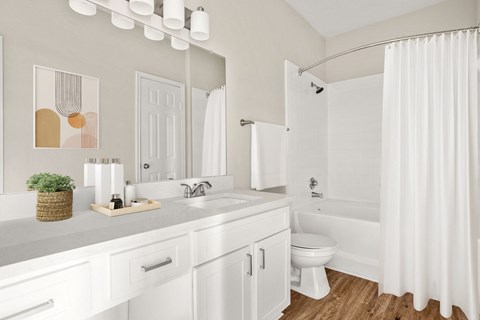 a white bathroom with a shower and a sink and a toilet at Veranda at Centerfield in Houston, TX