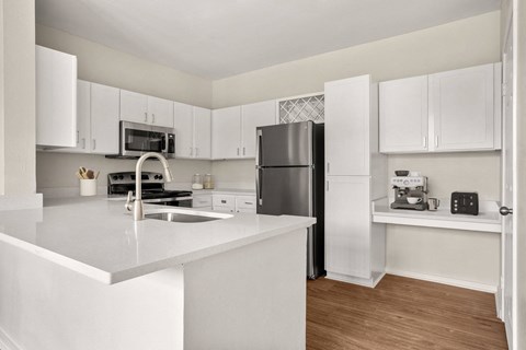commons apartment kitchen with stainless steel appliances at Veranda at Centerfield in Houston, TX 77070