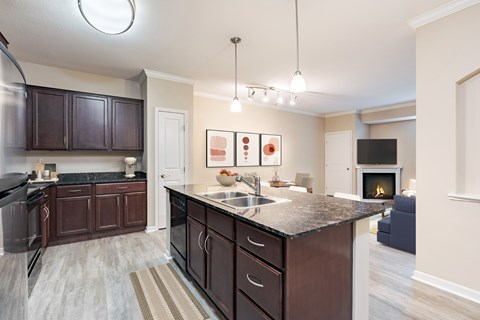 A kitchen with dark brown cabinets and a black stove top oven.