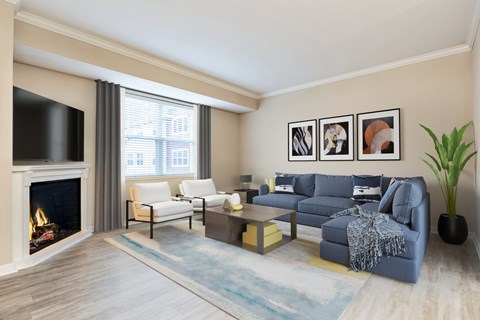 A living room with a fireplace and a blue couch.