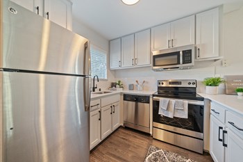 Bright and spacious kitchen with stainless steel appliances, updated cabinets, flooring and countertops - Photo Gallery 3