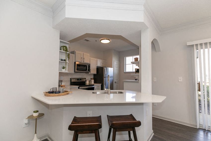a kitchen with an island and two stools