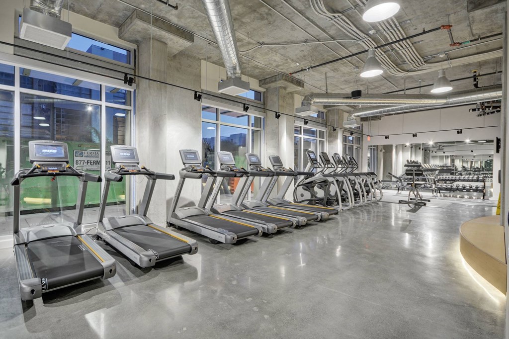 a gym with cardio equipment and treadmills in a building at L Seven, San Francisco