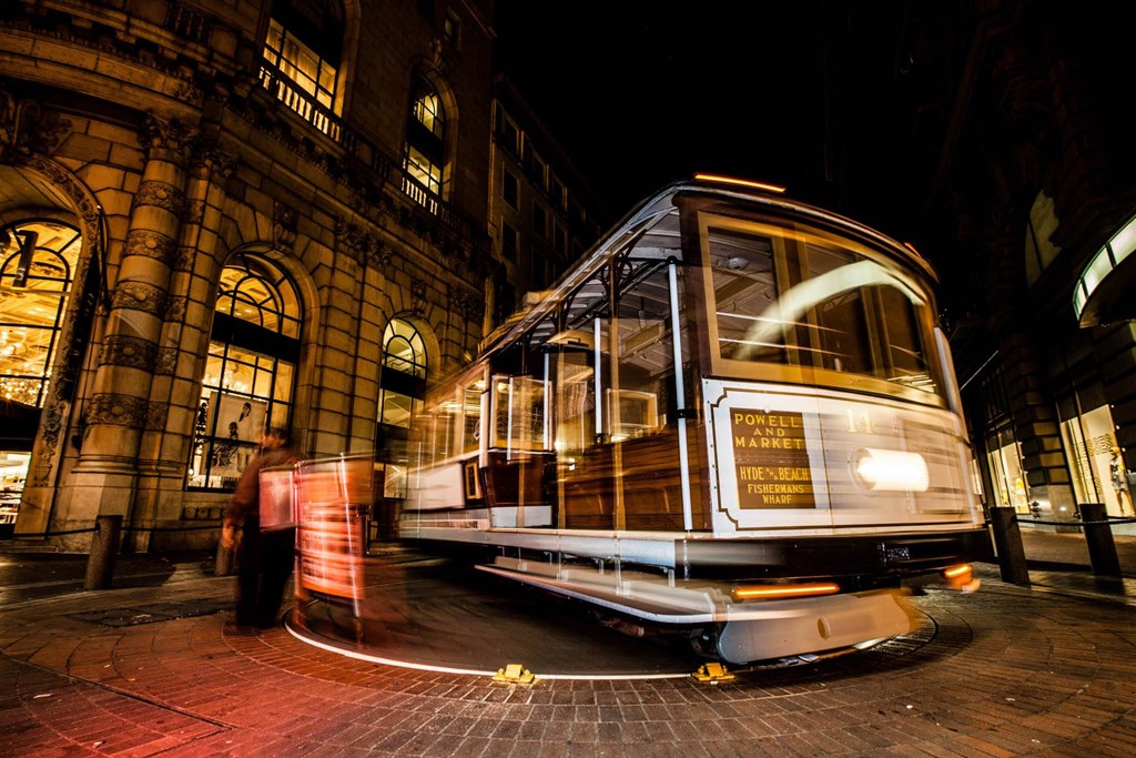 a trolley car on the street at night at L Seven, CA 94103