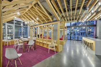 a dining room with tables and chairs and a building in the background at L Seven, California, 94103