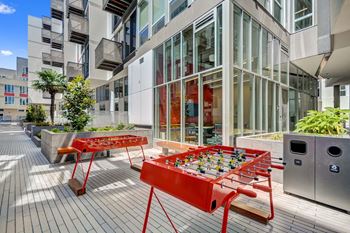 a foosball table on a patio in front of a building at L Seven, CA 94103