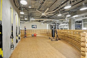 a gym with a row of benches and weights on the wall at L Seven, San Francisco, California 94103