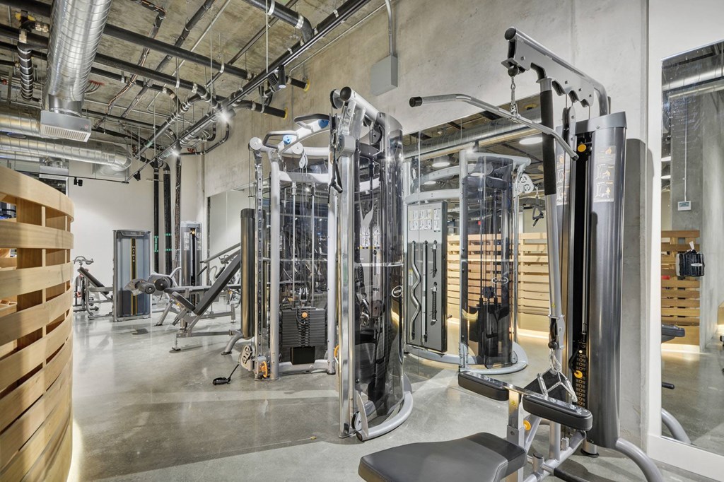 a gym with cardio machines and other equipment in a building at L Seven, San Francisco