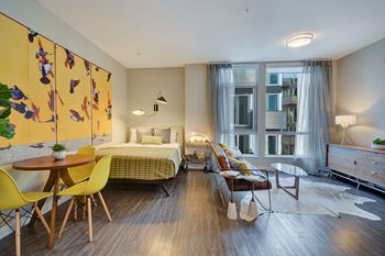 a bedroom with a bed and a living room with a table and chairs at L Seven, San Francisco, 94103