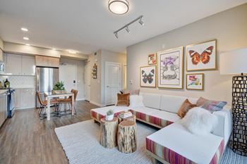 a living room with a white couch and a kitchen with a table at L Seven, San Francisco