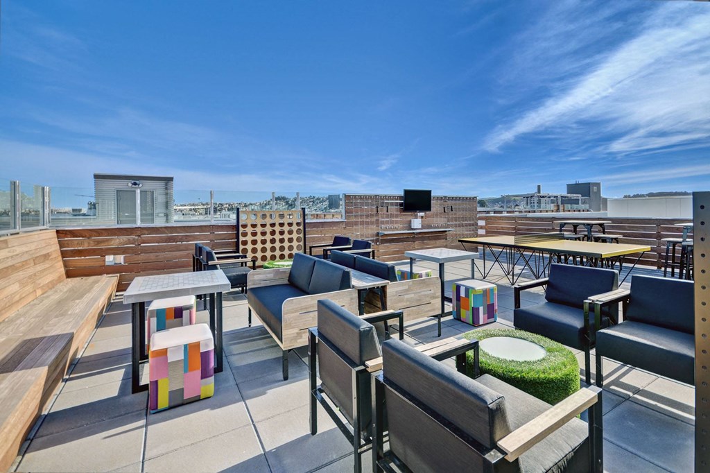 a roof top patio with tables and chairs and a view of the city at L Seven, San Francisco, 94103