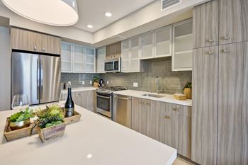 a kitchen with stainless steel appliances and white counter tops at L Seven, San Francisco, CA
