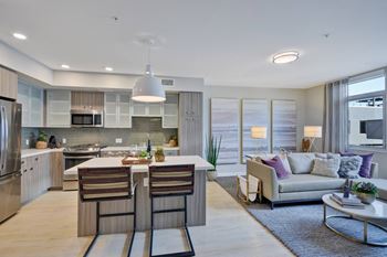 a living room with a kitchen and a couch at L Seven, California
