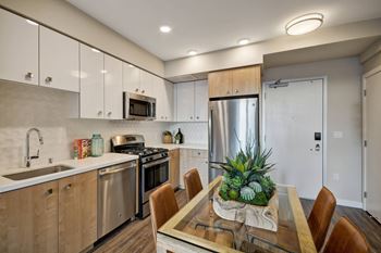 stainless steel appliances and a table with chairs at L Seven, CA 94103