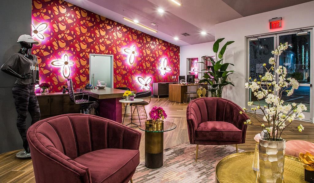 a lobby with red chairs and a red wall