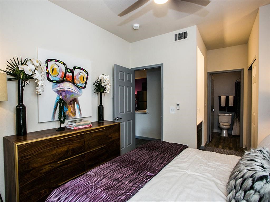 a bedroom with a bed and a door to a bathroom