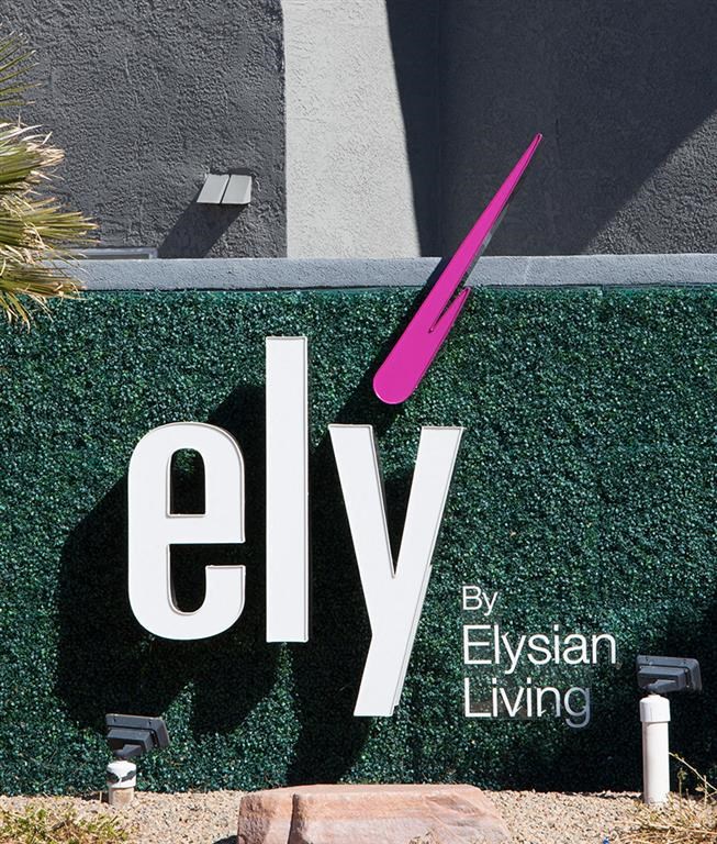 a sign on the side of a building with a pink