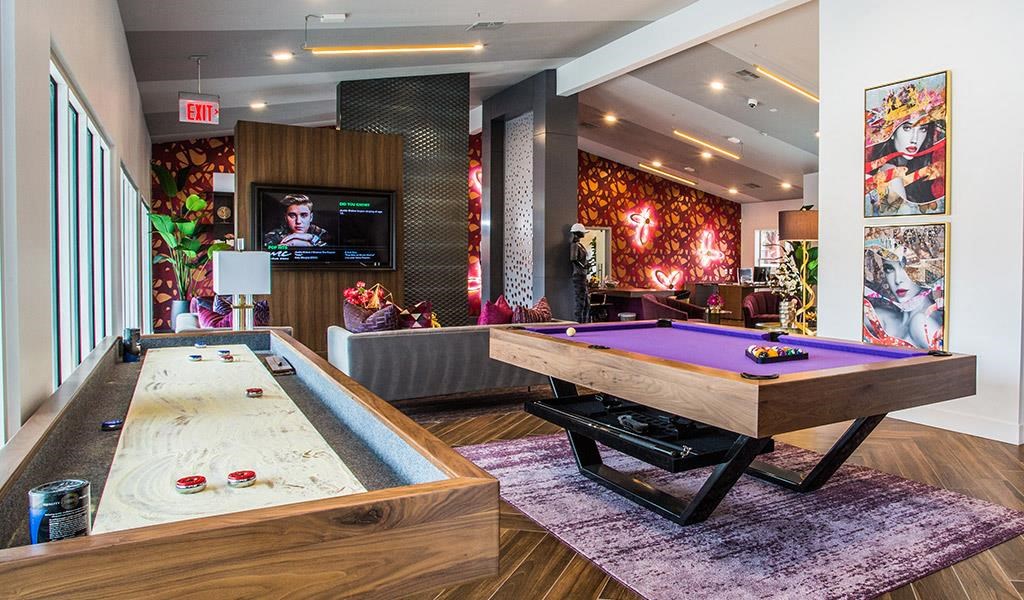 a game room with a pool table and a tv