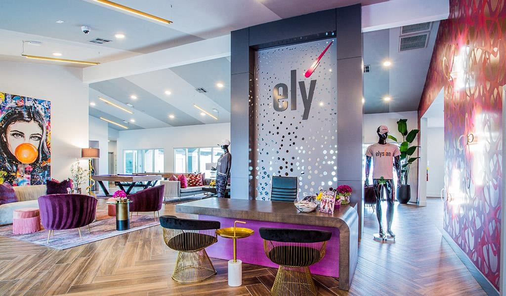 a room with a table and chairs and a wall with a logo