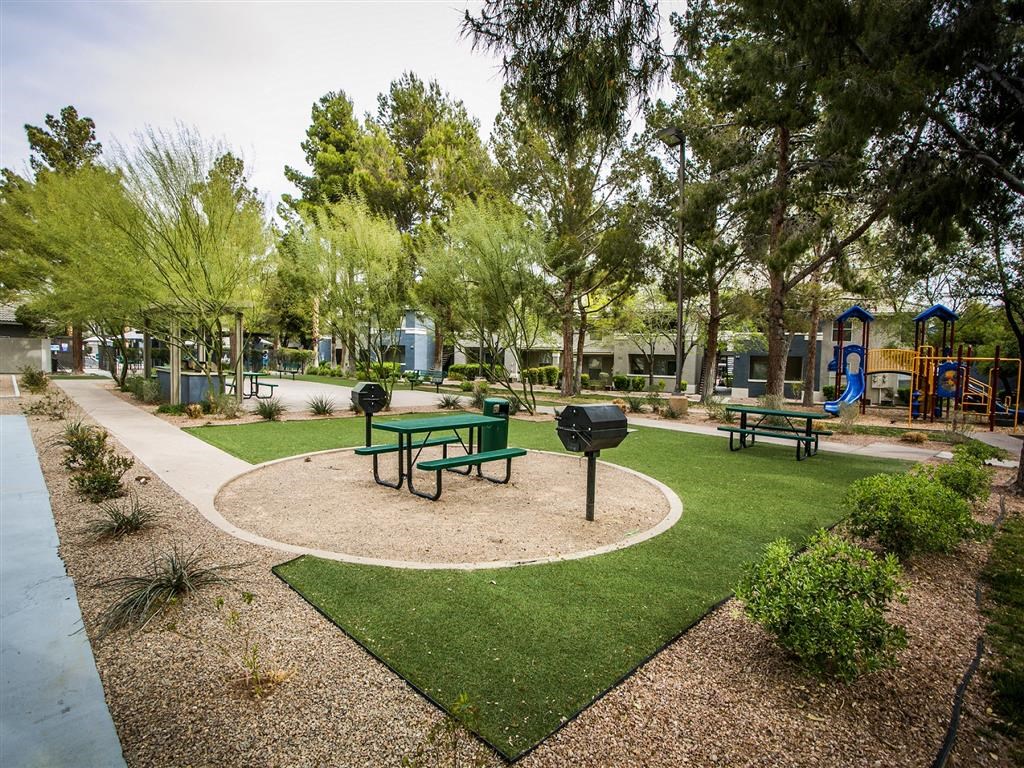 a park with a playground and picnic table