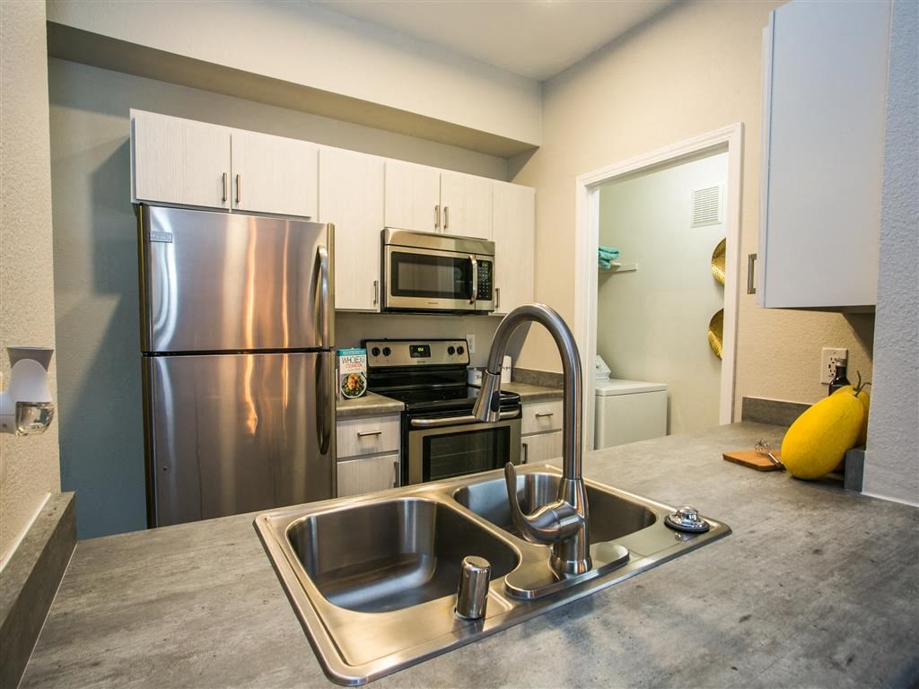a kitchen with stainless steel appliances and a sink
