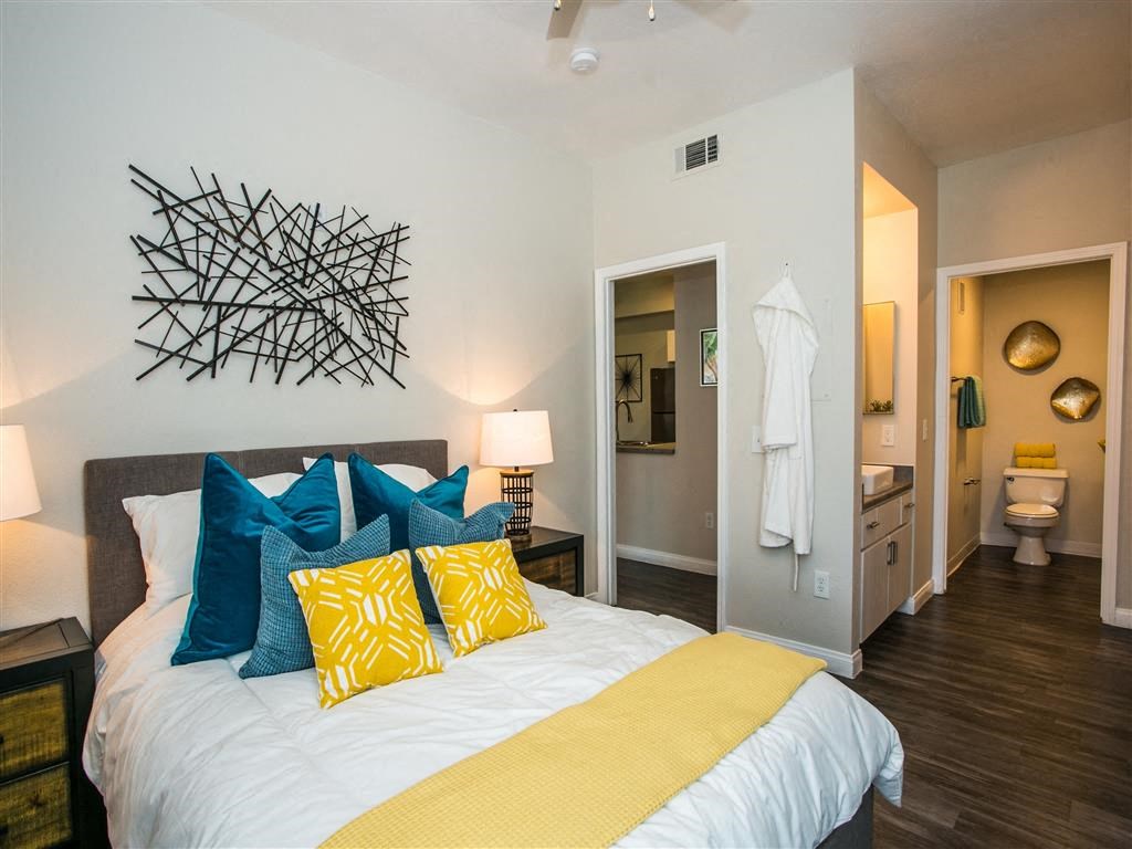 a bedroom with a bed and a bathroom