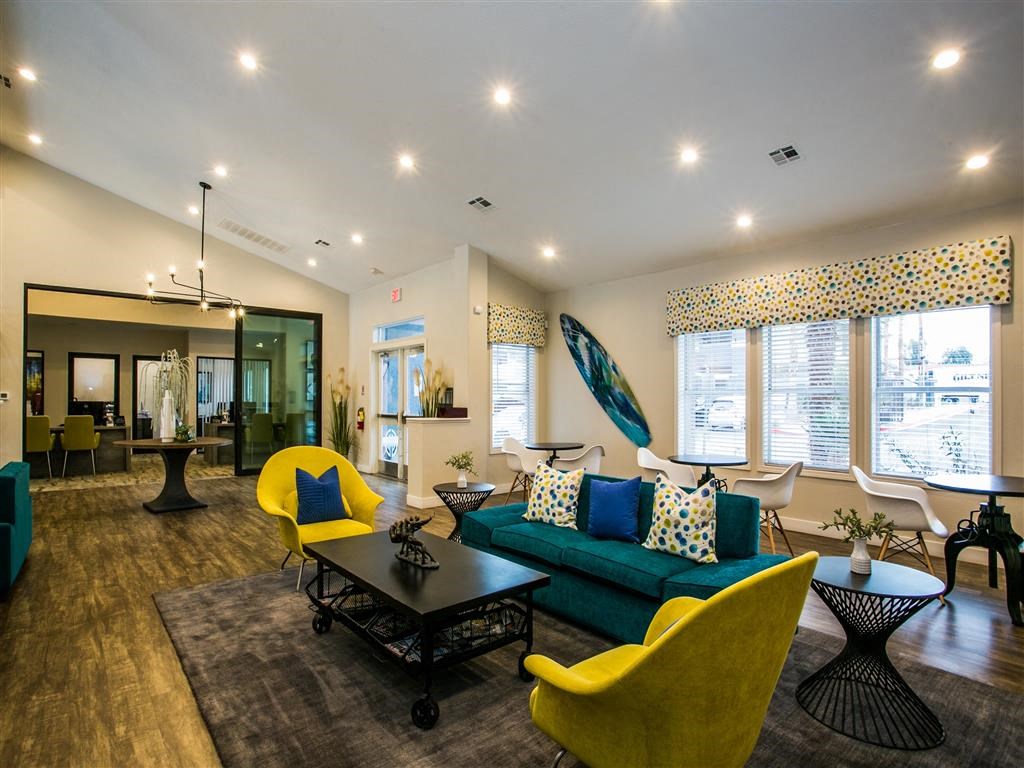 a living room with yellow chairs and a blue couch