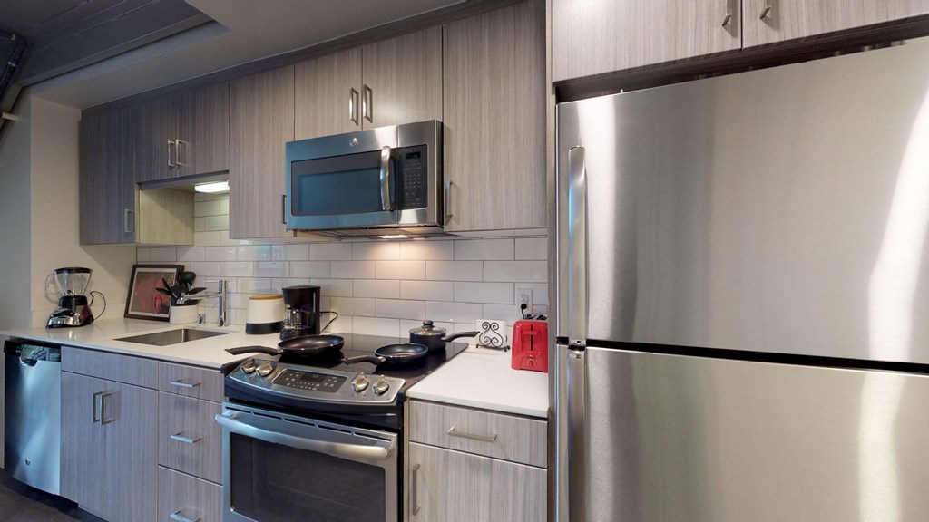 a kitchen with a stove and a refrigerator