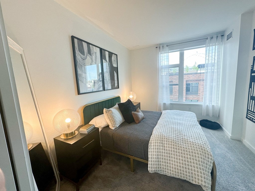 a bedroom with a bed and a large window at The Parker Apartments, Portland, 97209