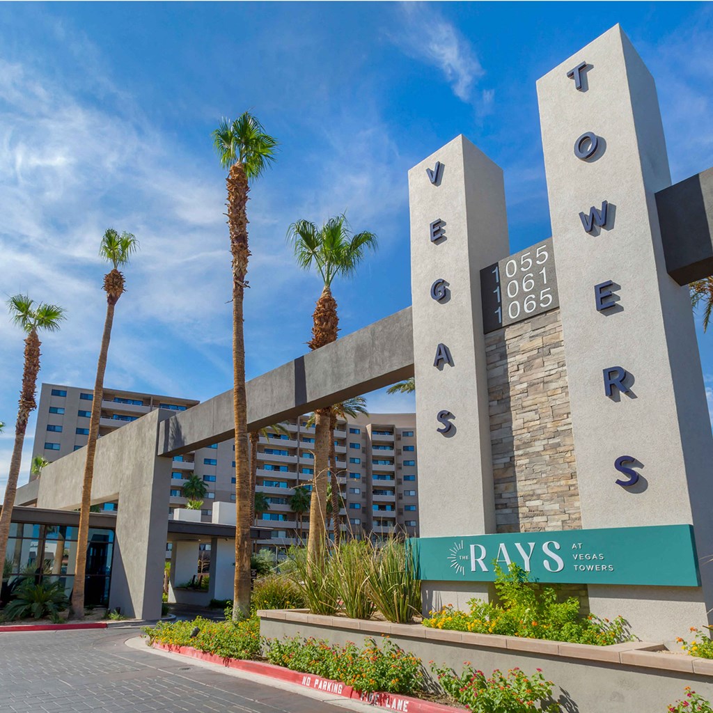 a city with palm trees in front of a building at The Rays at Vegas Towers Apartments, Las Vegas, NV