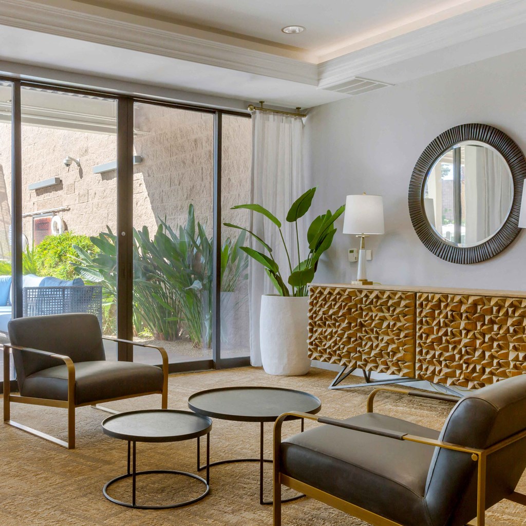 a living room with a couch and chairs and a window at The Rays at Vegas Towers Apartments, Las Vegas, Nevada