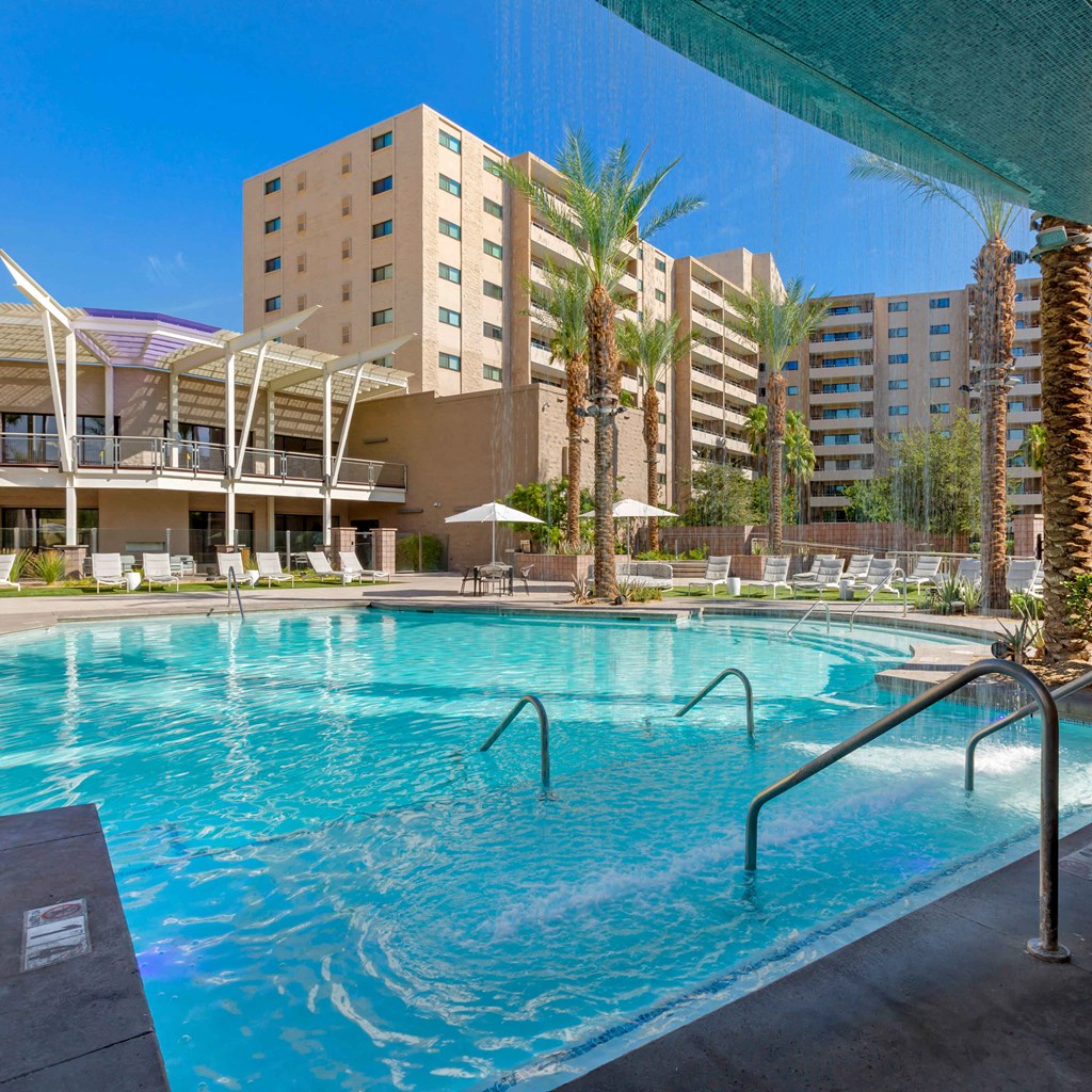 a swimming pool at a hotel with a building in the background at The Rays at Vegas Towers Apartments, Nevada, 89119