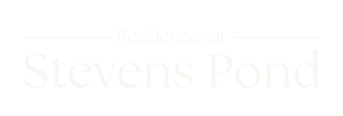 A green sign that says Residences at Stevens Pond.