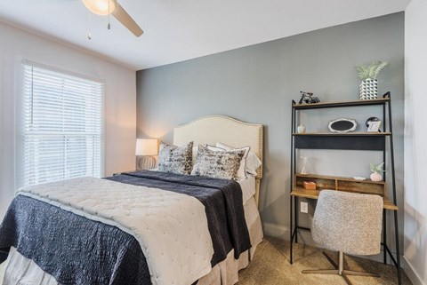 a bedroom with a bed and a nightstand at The Merchant Apartments, South Carolina